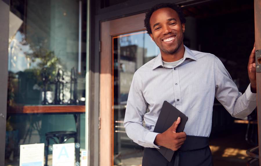 Restaurant owner standing on the doorway