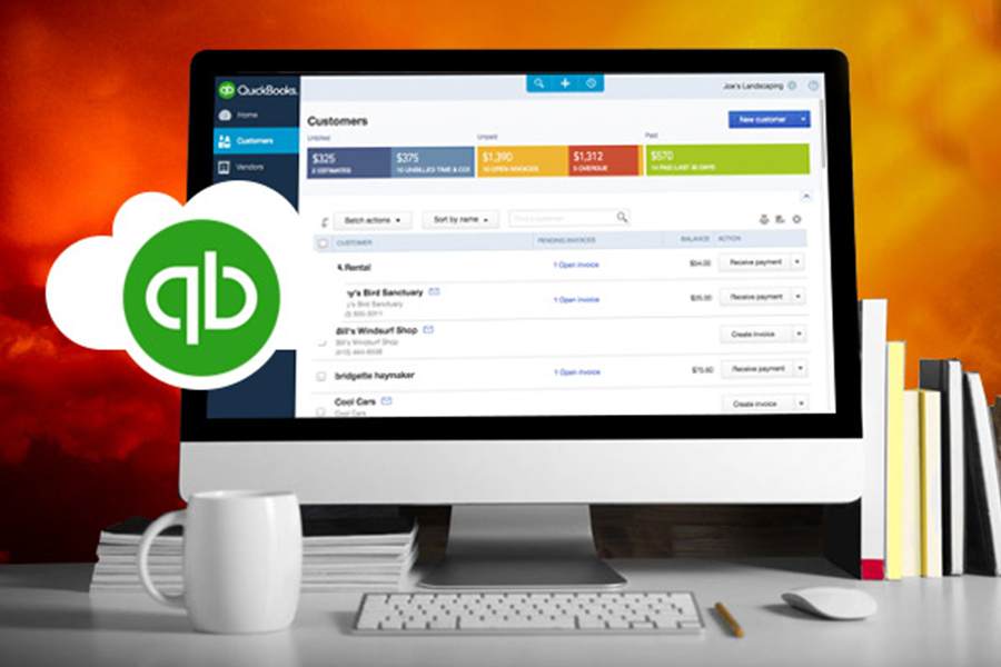 Desktop computer with QuickBooks Online on the screen.