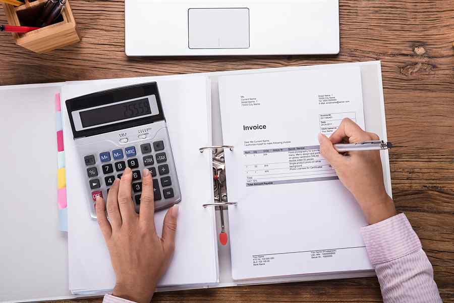 Woman using a calculator to calcul.