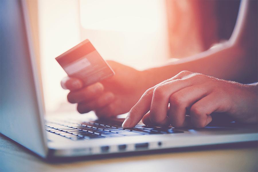 Girl making a payment online using her credit card.