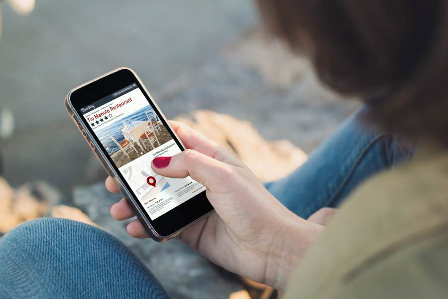 Woman browsing a directory site on her phone.