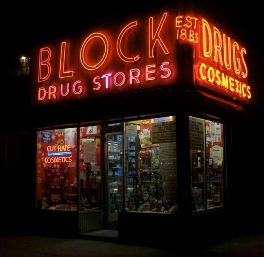 显示一个照明标志的街区药店。