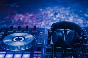 Party dj headphones placed beside the mixer.