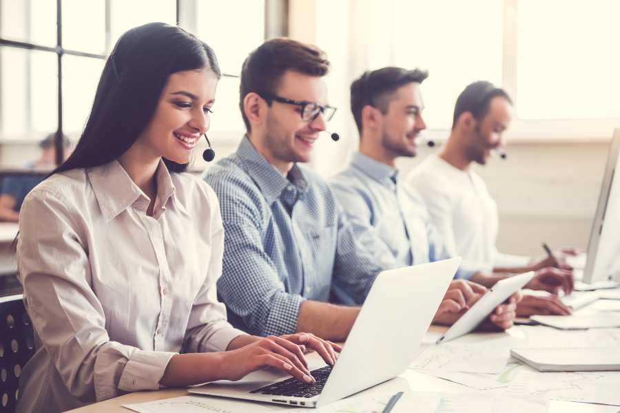 Customer service representative smiling while working in the office.