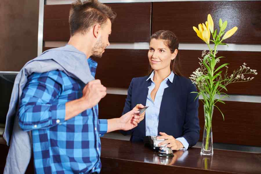 Man paying his hotel stay using credit card.