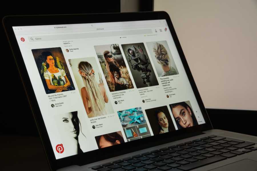 显示Pinterest's page on a laptop screen.