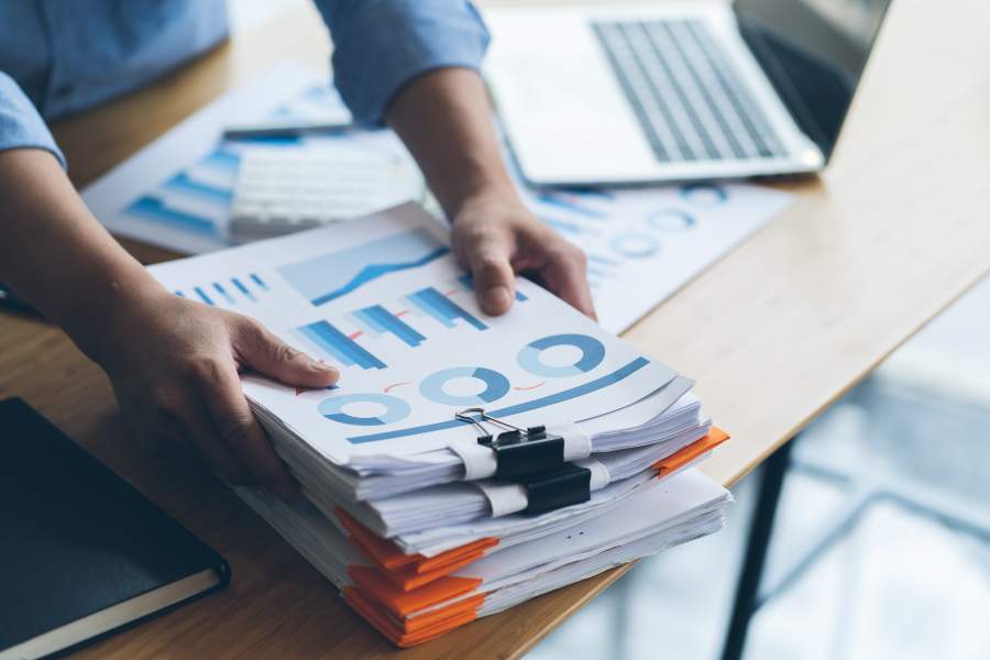 Businessman preparing for reports with graphs and charts.