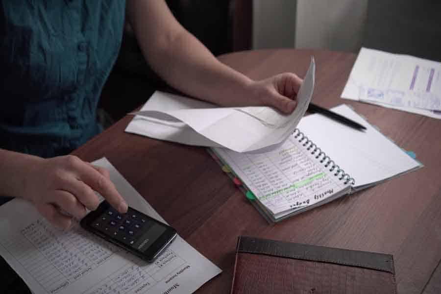 An employee is checking reciepts and doing inventory.