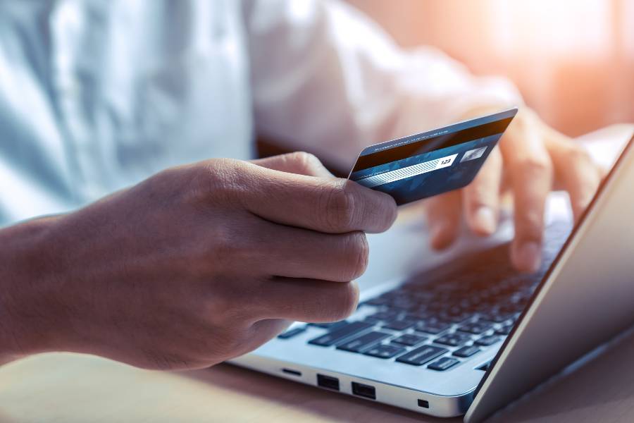 Young man use credit card for online payment.