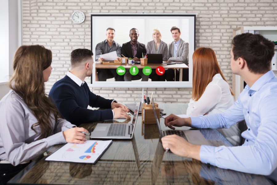 Group Of Business People Doing Video Conferencing In Business Meeting At Office.