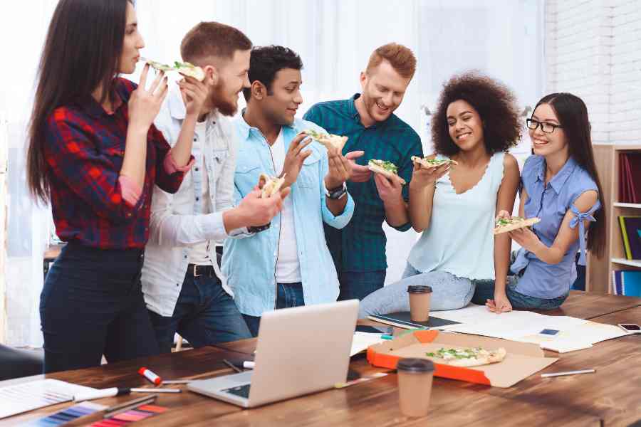 Employees are happily eating thier meals.