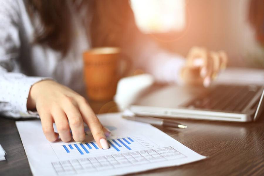 A woman pointing at a chart.