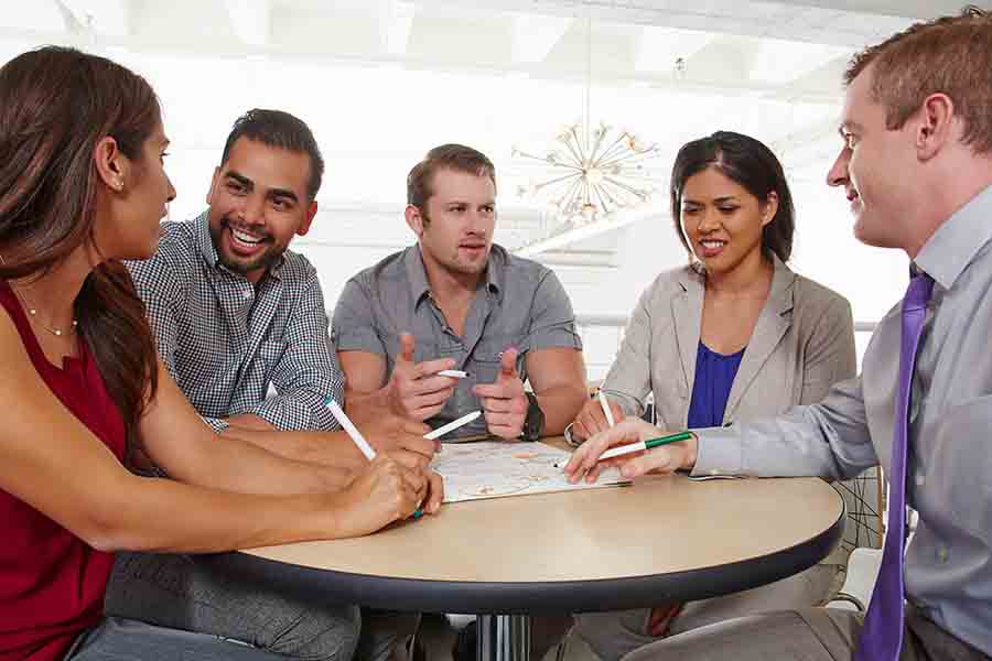 Small group of people having brainstorming business meeting.