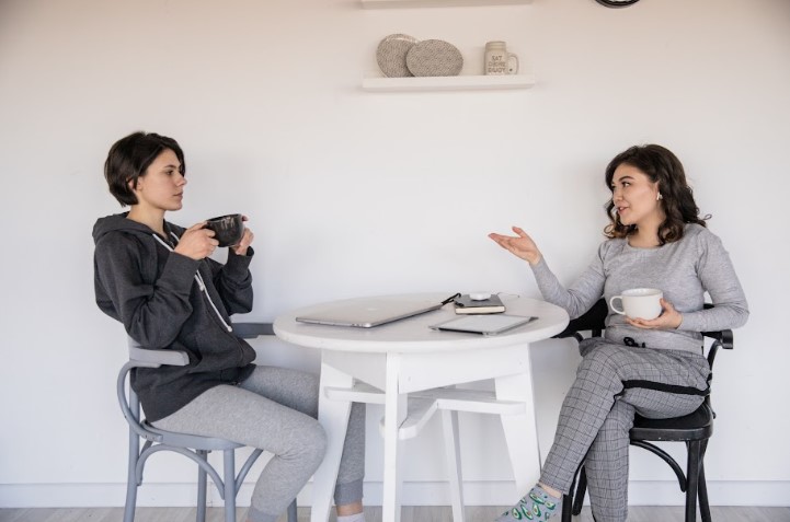 Two friends chatting over coffee