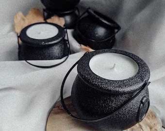 Candles in mini cauldrons.