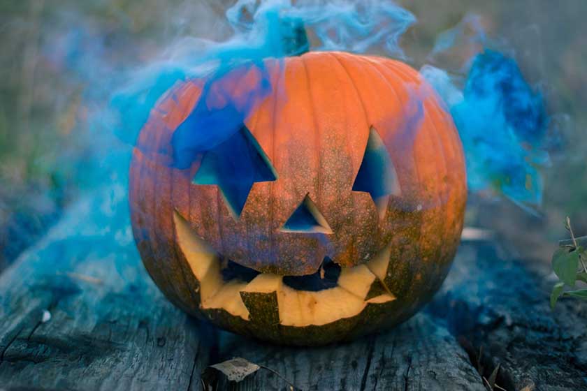 Carved pumpkin Halloween decor with fog.