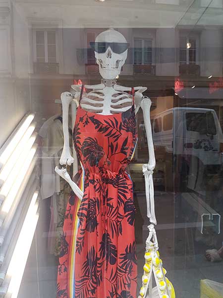 Skeleton dressed in a red dress for a retail store display.
