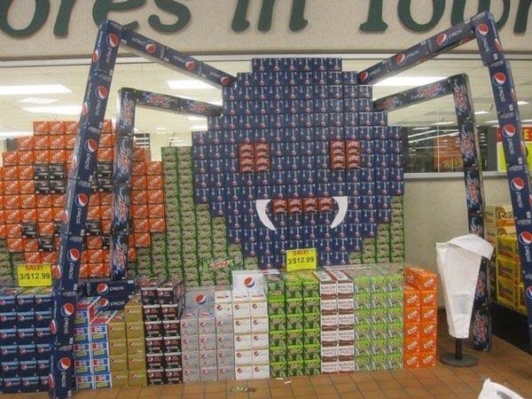 Soda boxes arranged to create a spider-shaped display.